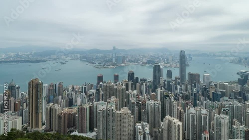 HONG KONG, CHINA - APRIL 2, 2019: 4K Cinematic Zooming In Time Lapse Footage of Victoria Harbour taken from The Peak in Hong Kong during cloudy day.