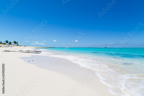 Gorgeous white sand beach and blue sky on Turks and Caicos Islands. 