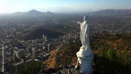 Aerial drone view of Virgin Mary statue at the top of Cerro Cristobal in Santiago, Chile.