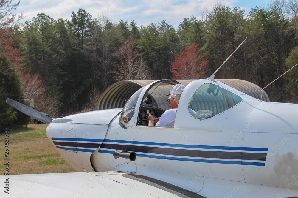 Fototapeta premium Active Senior Man getting ready for takeoff by programming his flight plan
