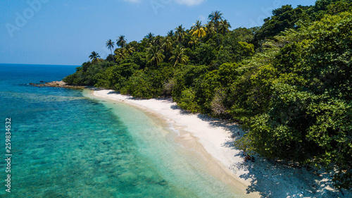 Amazing aerial view of tropical beach with nobody in summer. Vacation destination in Malaysia. Tropical sand beach with palm trees and crystal water