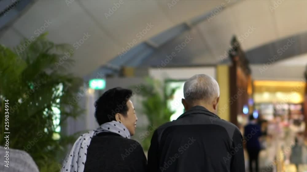 Asian senior couple walking in airport fun trip Asian senior couple walking in airport fun trip