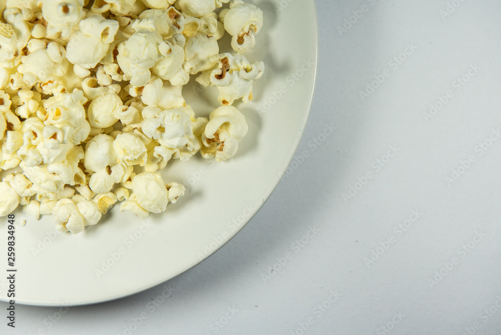 Popcorn in a plate on white background Popcorn in a plate on white background