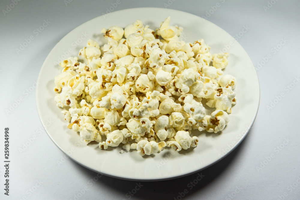 Popcorn in a plate on white background