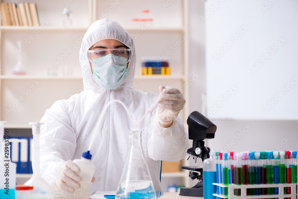 Young handsome chemist working in the lab Young handsome chemist working in the lab