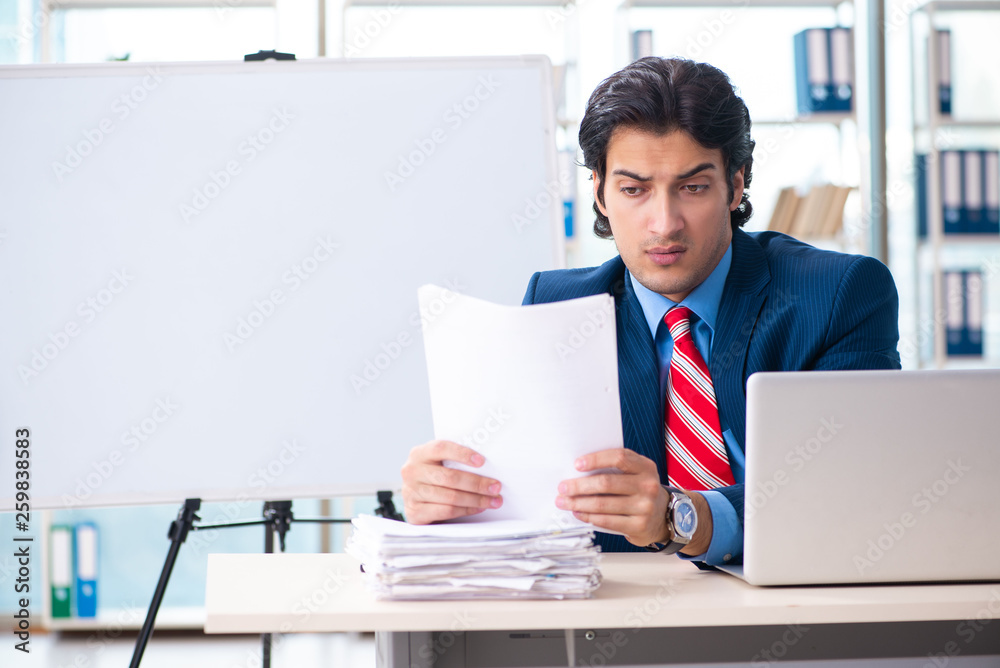 Young handsome businessman in front of whiteboard Young handsome businessman in front of whiteboard