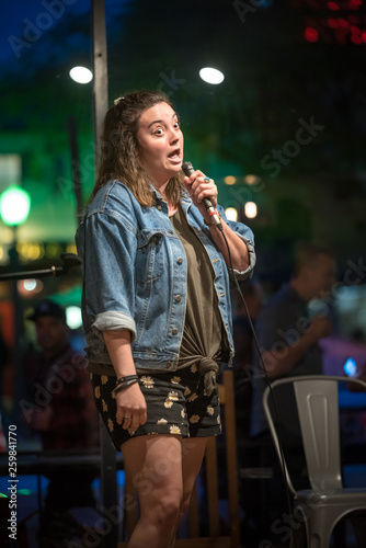 Talented female comedian performs her stand up at a local night spot open mic in Escondido, California