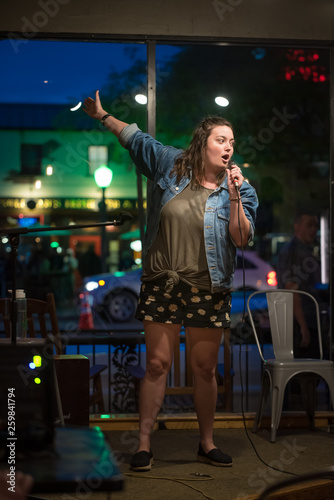 Talented female comedian performs her stand up at a local night spot open mic in Escondido, California