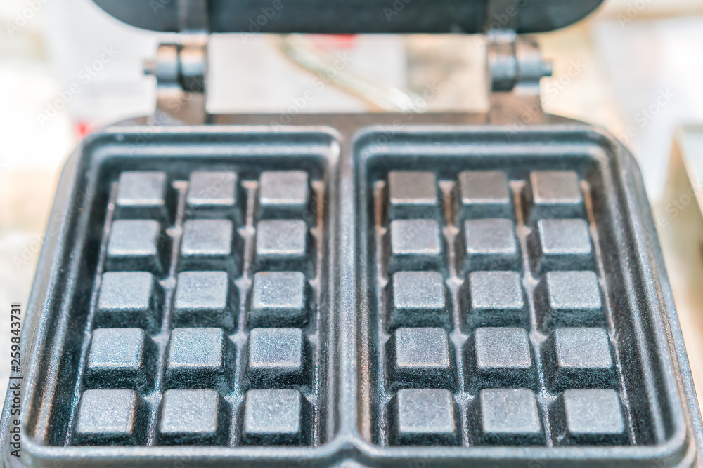 Close up waffle pan square shape made from metal or cast iron or aluminum Close up waffle pan square shape made from metal or cast iron or aluminum