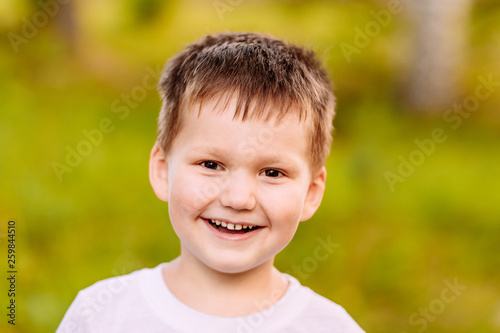 the five-year child smiling on blurred background