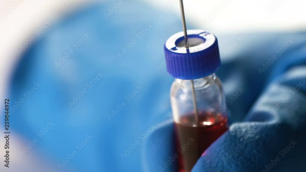 doctor gaining medication from the vial into the syringe doctor gaining medication from the vial into the syringe