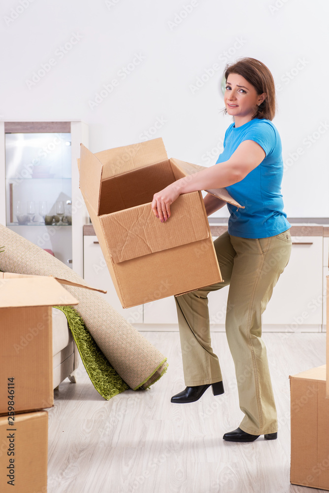 Middle-aged woman moving to new flat Middle-aged woman moving to new flat