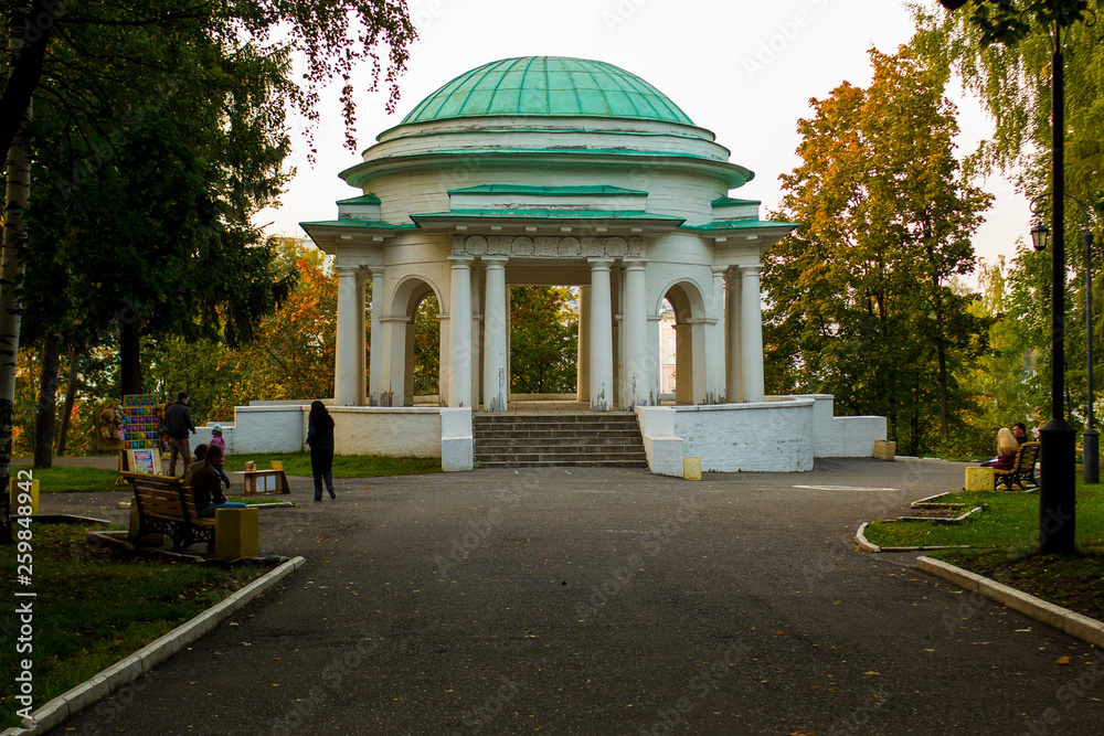 wooden old rotunda in the summer Park