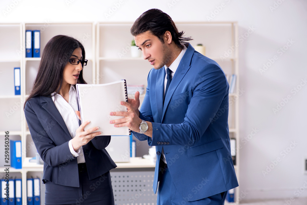 Two employees working in the office Two employees working in the office