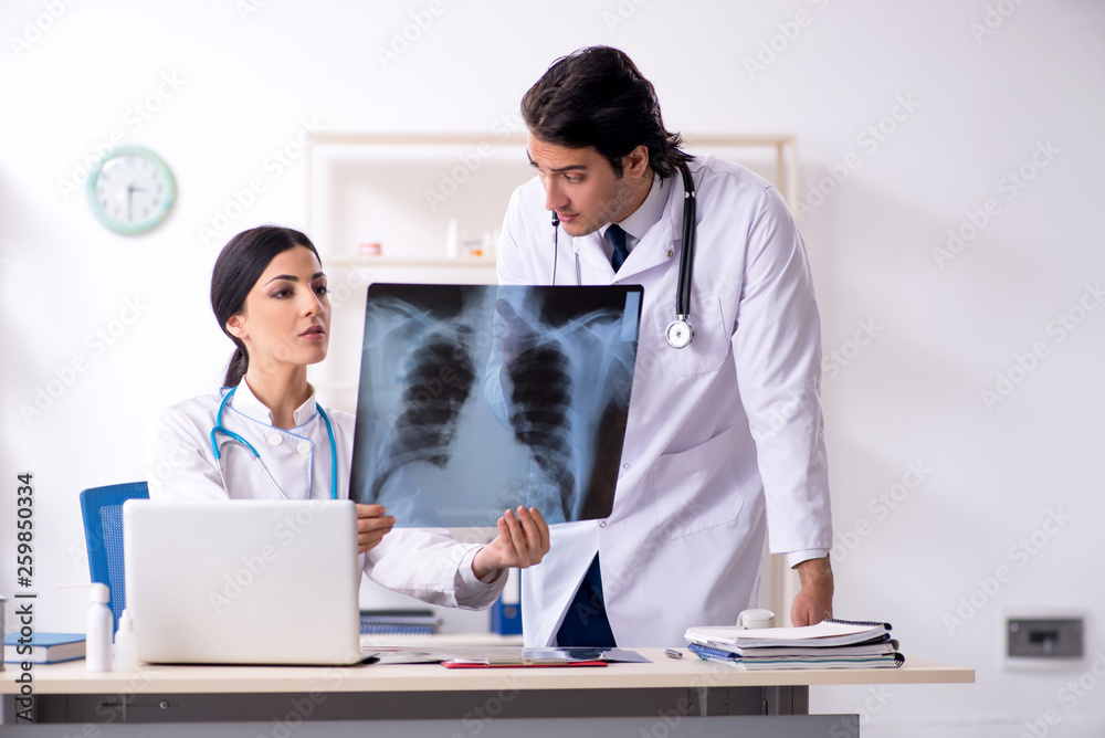 Two young doctors working in the clinic Two young doctors working in the clinic