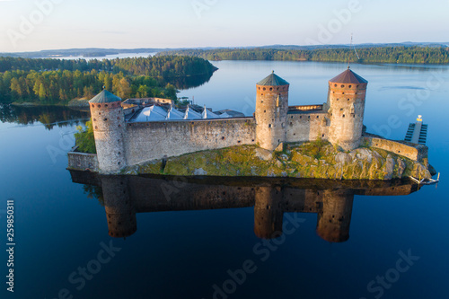 Olavinlinna fortress in the morning summer landscape (aerial photography). Savonlina, Finland photo