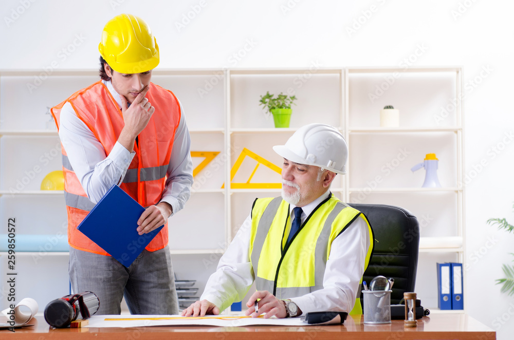 Two engineers colleagues working under project Two engineers colleagues working under project