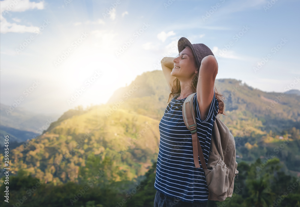 Young beautiful woman traveler enjoys mountain, beautiful landscape and active lifestyle. Sri Lanka - Ceylon Island