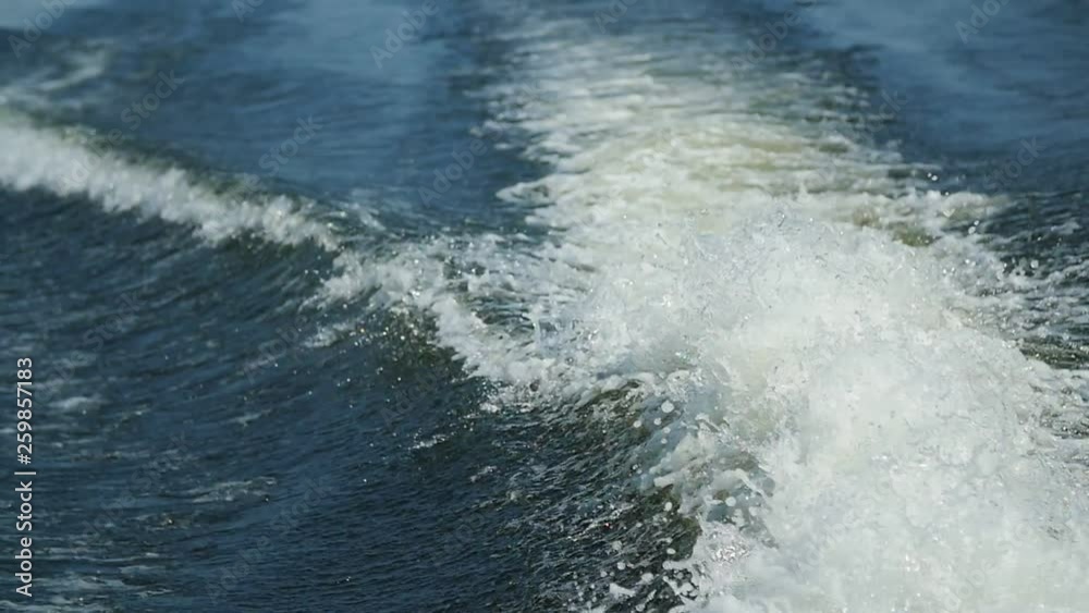 View from a stern of floating boat in the river. Waves and splashes on the water from a boat View from a stern of floating boat in the river. Waves and splashes on the water from a boat