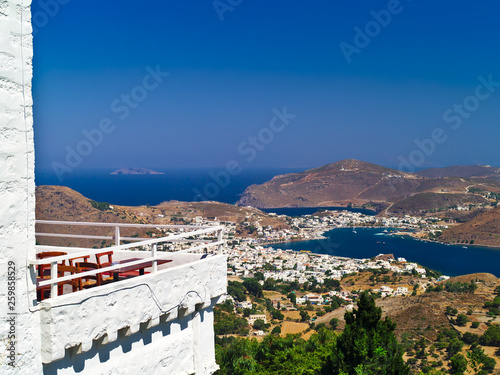 Wallpaper Mural Distant view of Skala village on Patmos island in Greece. Traditional house balcony on foreground. Summer deep blue sky. Torontodigital.ca