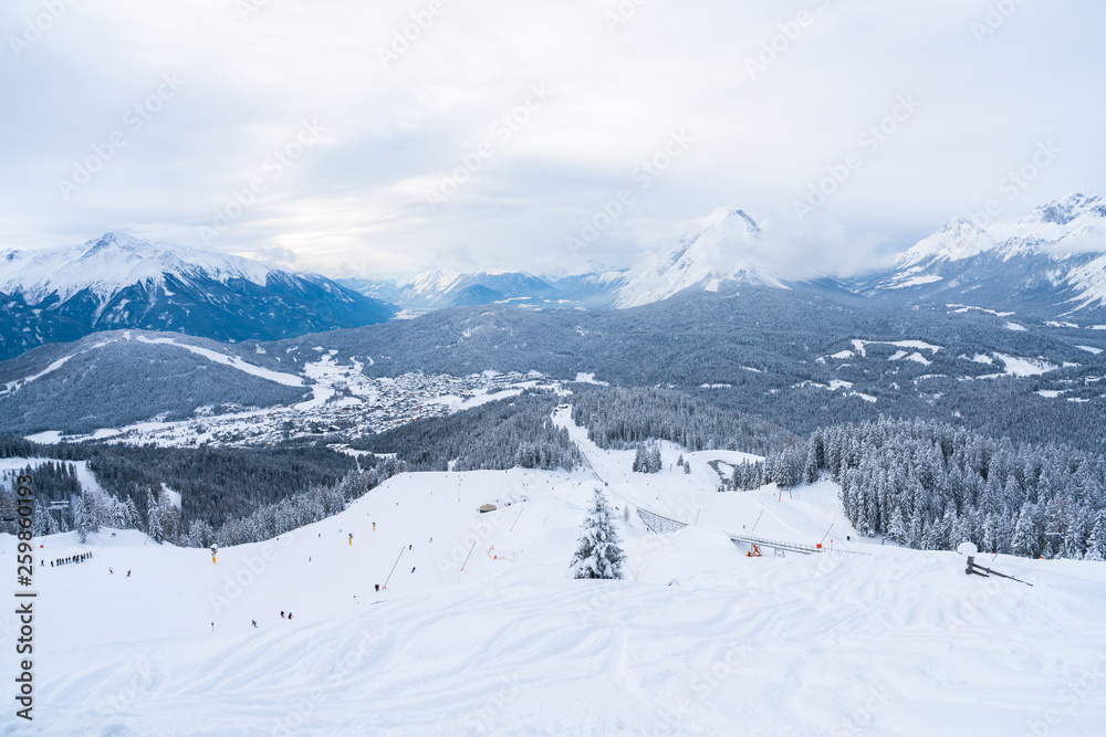 Winter landscape with snow covered Alps, ski slopes and aerial view of Seefeld in the Austrian state of Tyrol. Winter in Austria