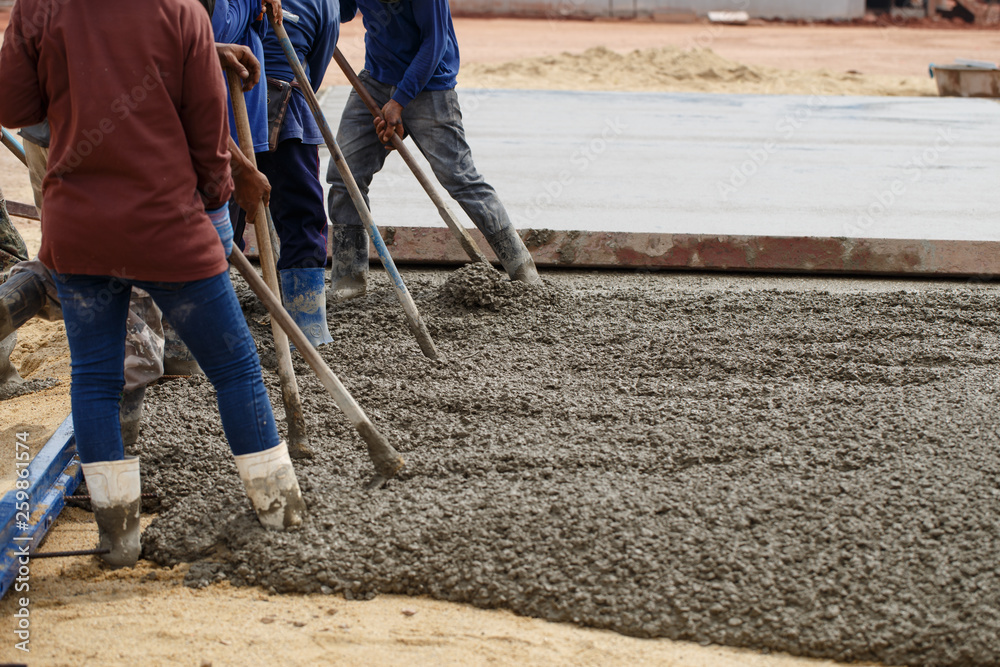 Workers are cementing for road construction Workers are cementing for road construction