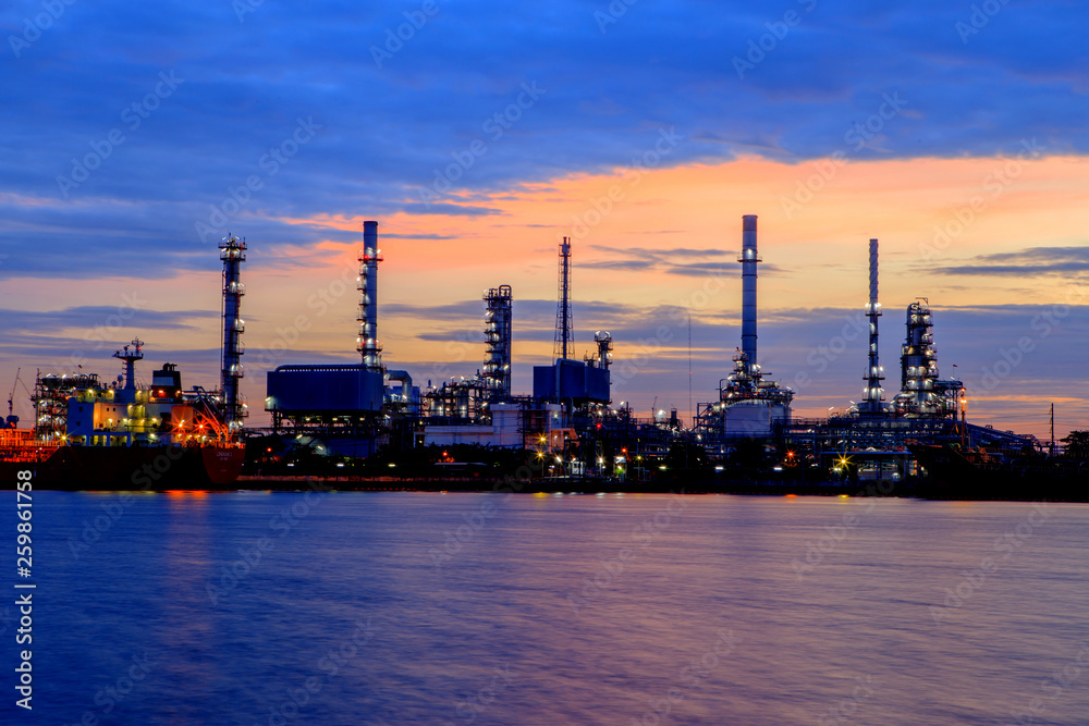 Oil refinery with water reflection before sunrise