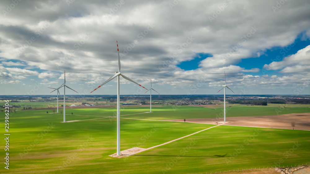 Flying above white wind turbines as pure energy