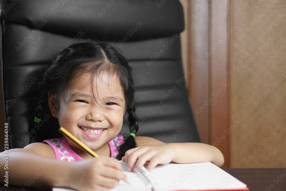 asian child student or kid girl write diligent with enjoy doing homework or learning writing note on white paper book and desk or table with happy smiling at preschool nursery or kindergarten office asian child student or kid girl write diligent with enjoy doing homework or learning writing note on white paper book and desk or table with happy smiling at preschool nursery or kindergarten office