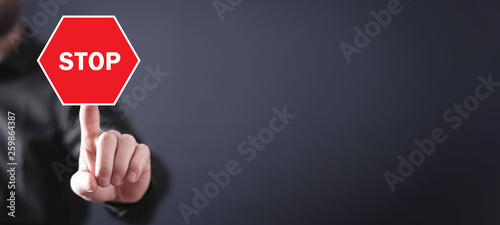 Man hand with a red stop sign.