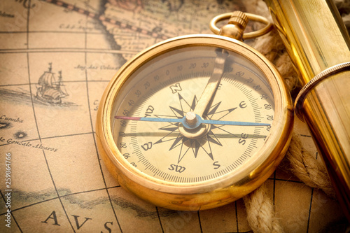 compass with spyglass on old map