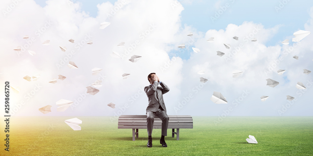 Young man in summer park on bench do not want to see anything Young man in summer park on bench do not want to see anything