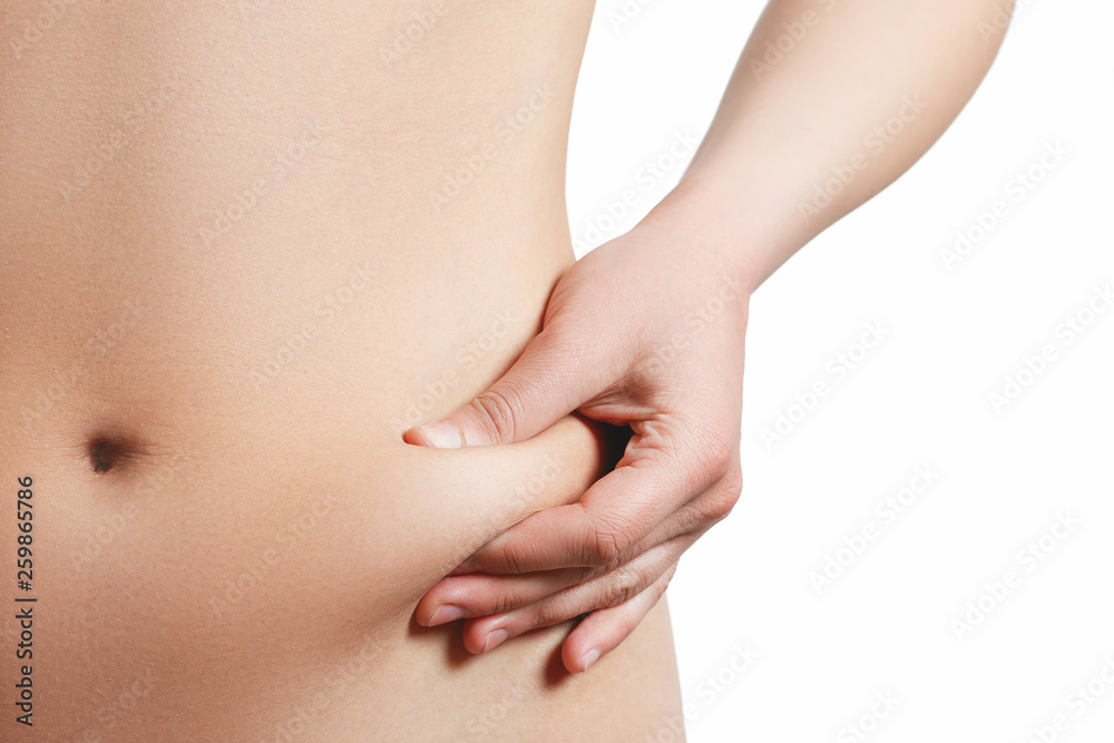 Midsection view of a woman pinching skin for fat test Isolated on white background