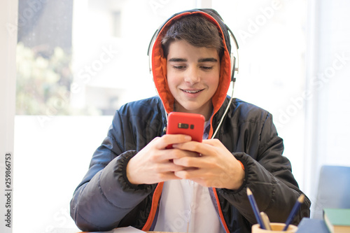 teenager or student with mobile phone and headphones
