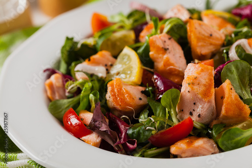 Fototapeta Naklejka Na Ścianę i Meble -  Delicious salad with pieces of grilled salmon.