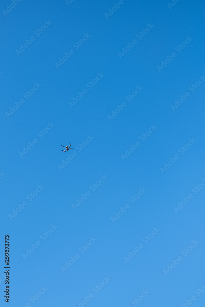 flying mechanism-drone in the blue sky, with space for text flying mechanism-drone in the blue sky, with space for text
