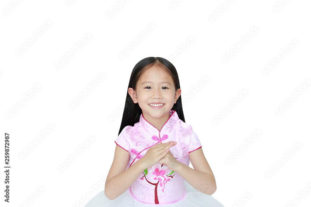 Happy little Asian child girl wearing pink traditional chinese dress with greeting gesture celebration for Chinese New Year isolated on white background. Happy little Asian child girl wearing pink traditional chinese dress with greeting gesture celebration for Chinese New Year isolated on white background.