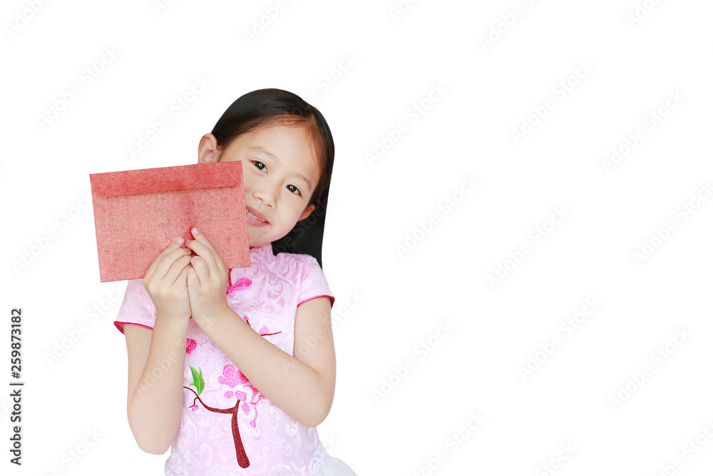 Happy little Asian child girl wearing pink traditional cheongsam dress smiling while receiving Chinese New Year red envelope packet isolated on white background. Happy chinese new year concept. Happy little Asian child girl wearing pink traditional cheongsam dress smiling while receiving Chinese New Year red envelope packet isolated on white background. Happy chinese new year concept.