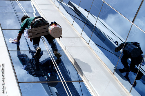 The building cleaner is climbing for clean building