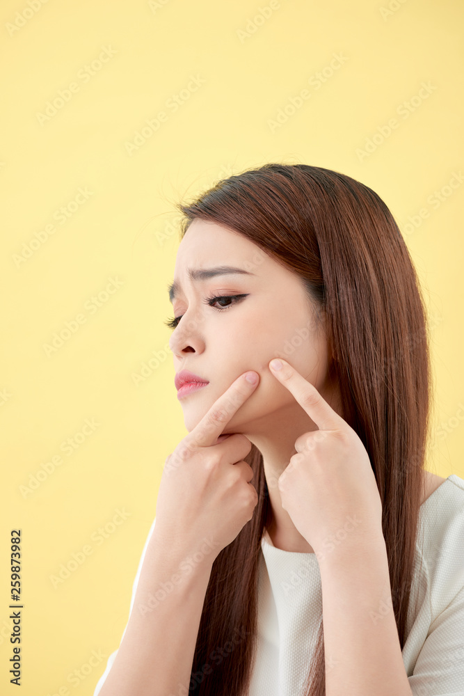 Face Skin Problem - young woman unhappy touch her skin isolated, concept for skin care, asian Face Skin Problem - young woman unhappy touch her skin isolated, concept for skin care, asian