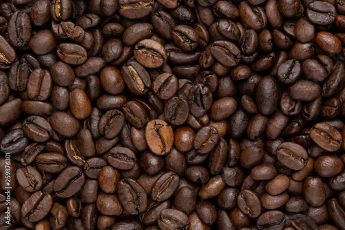 Background of dark coffee beans, top view