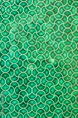 green mosaic tile with arabic pattern