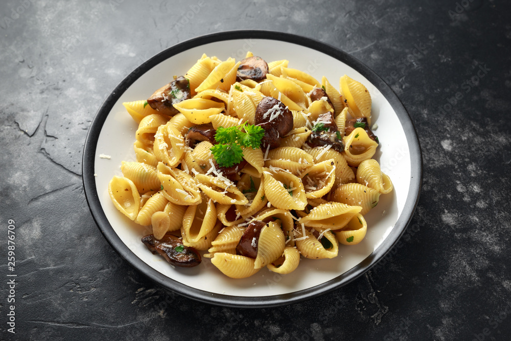 Conchiglie pasta with mushrooms, creamy sauce, parmesan cheese and herbs