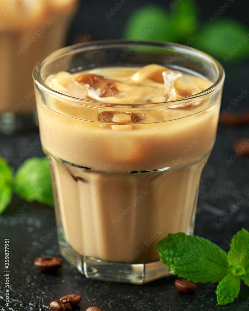 iced caramel coffee in a glass with cold milk. Summer drink iced caramel coffee in a glass with cold milk. Summer drink