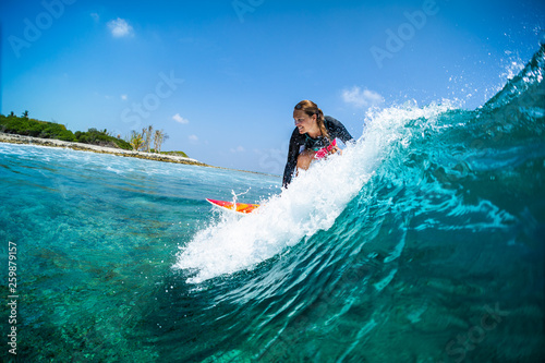 Photography Happy lady surfer rides the tropical wave at sunny day