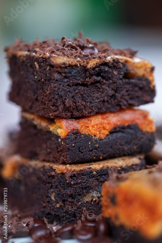 close up detail of homemade chocolate brownies with toppings of grains and grated chocolate