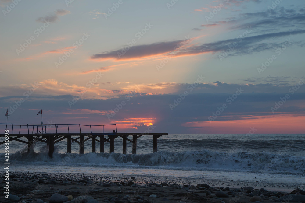 sun setting over Terrace dock or pier. Jetty sea and cloudy sky background, sunset