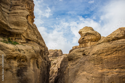 canyon wilderness scenic landscape sand stone Middle East outdoor object foreshortening from below between bare steep rocks on blue sky background