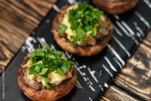 Stuffed mushrooms on a rough wooden surface