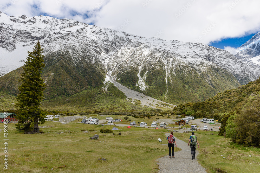 Tourists are returning to the base camp after walking along the Hooker Valley Track